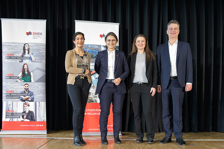 Gruppenbild auf einer Bühne mit schwarzem Vorhang. v.l.n.r.: Prof. Dr. Nicole Graf (Rektorin der DHBW Heilbronn), Prof. Dr. Marina Klärle (Präsidentin der DHBW), Brigitte Spriegel (Verwaltungsdirektorin der DHBW Heilbronn), Prof. Dr. Tomás Bayón (Prorektor der DHBW Heilbronn)