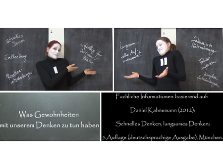 eine Frau mit weiß geschminktem Gesicht steht vor einer Tafel und zeigt auf Begriffe, die dort angeschrieben sind