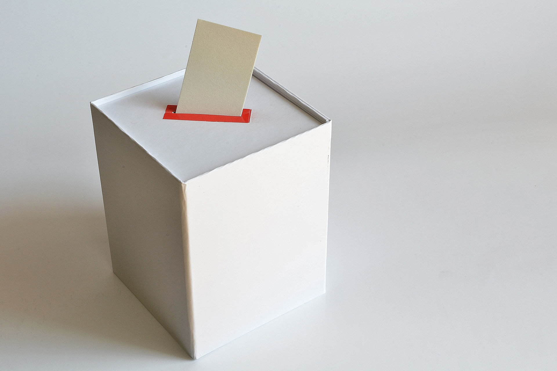 Wahlurne mit einem Stimmzettel im Einschubfach