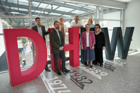 Die Mitglieder der Ethikkomission, gruppiert um den menschengroßen Schriftzug DHBW.